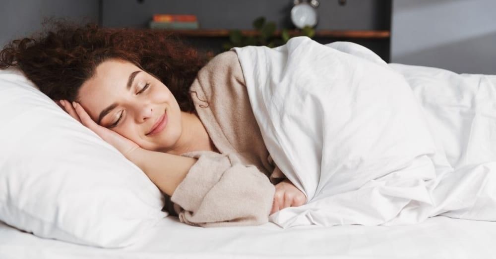 A Woman Sits On The Bed Beside A Face-down Man Coffee Mug by