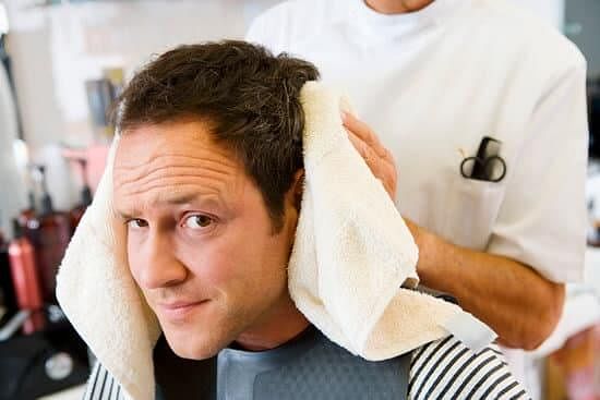 Barber caring for man's hair
