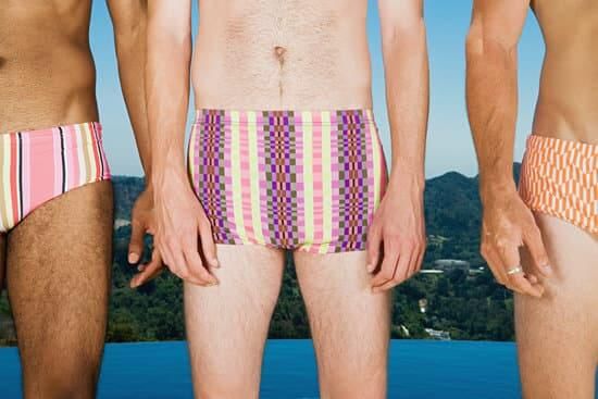 Row of men wearing swimming trunks